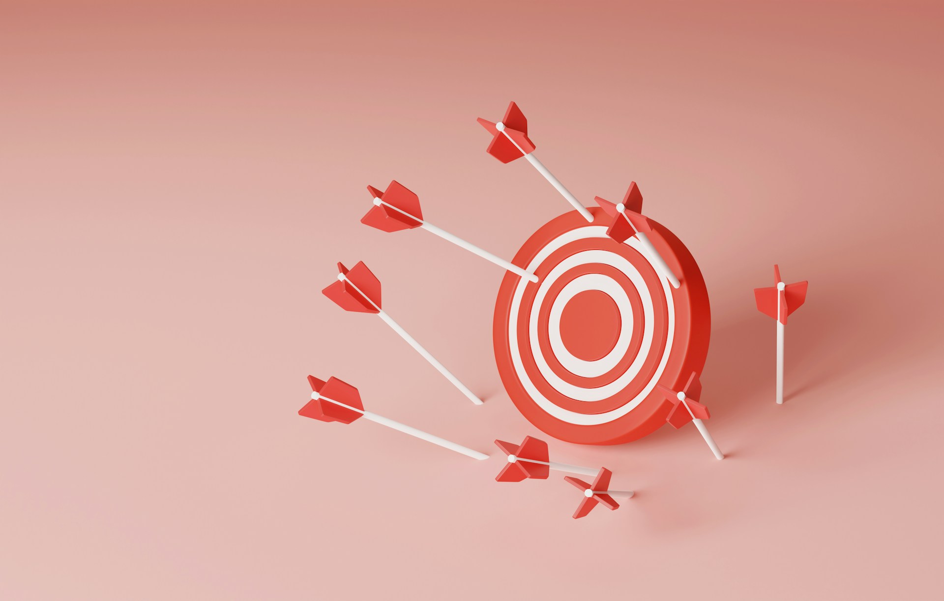 Red and white target with arrows striking, set against a soft pink background.